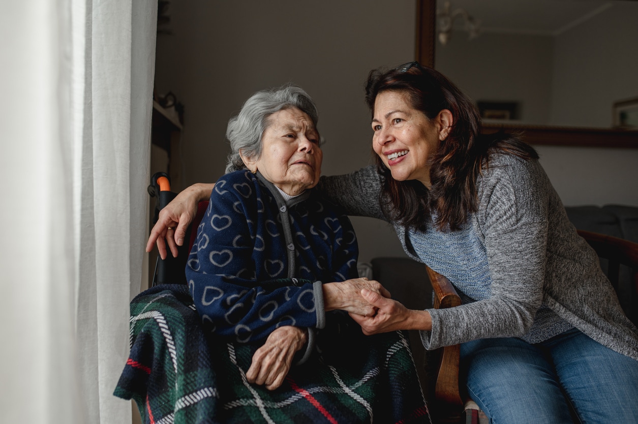 mother in a wheelchair sitting with daughter