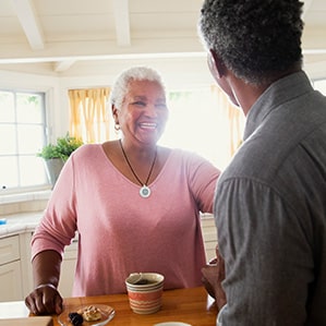 woman wearing HomeSafe and man drinking coffee