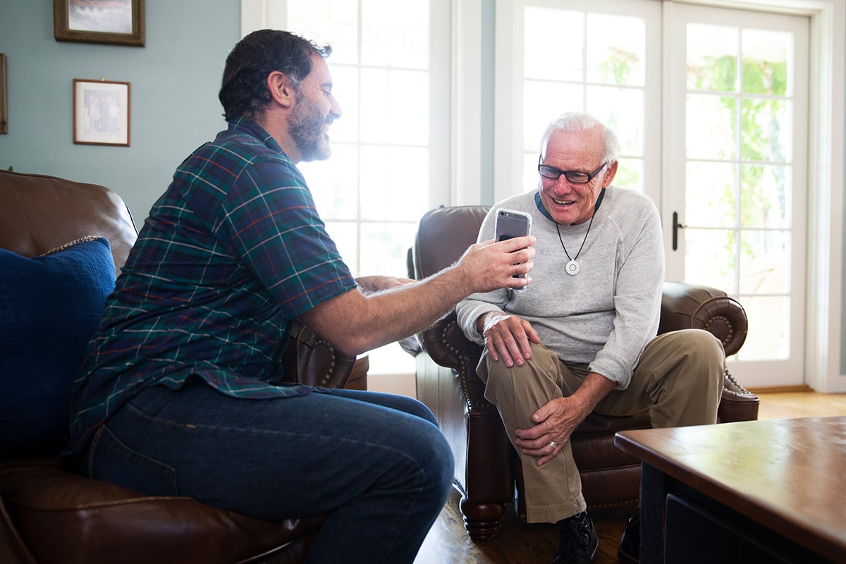 man showing father phone