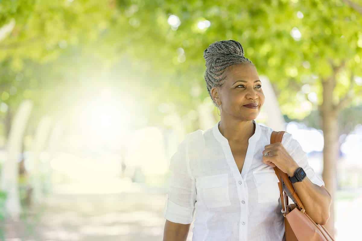 Woman in park wearing Lifeline Smartwatch